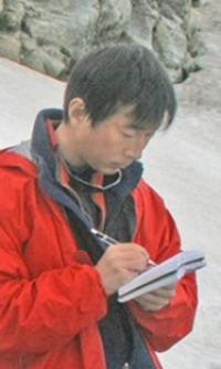 Yushin Ahn writing research notes in the Arctic.