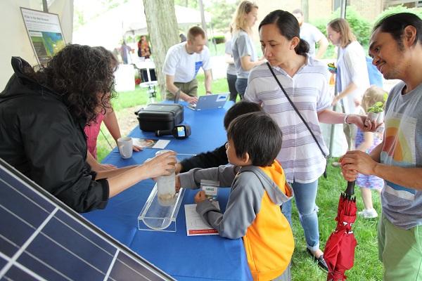 Parents look on as children learn about ice cores