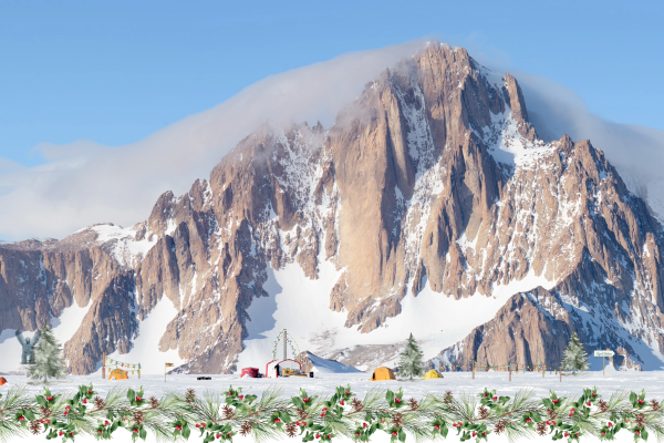 The Byrd Center Holiday card: an image of a mountain covered with snow with trees and tents at the base under blue sky and white clouds with a bow at the top left edge of the framed image with garland at bottom, under the image. 