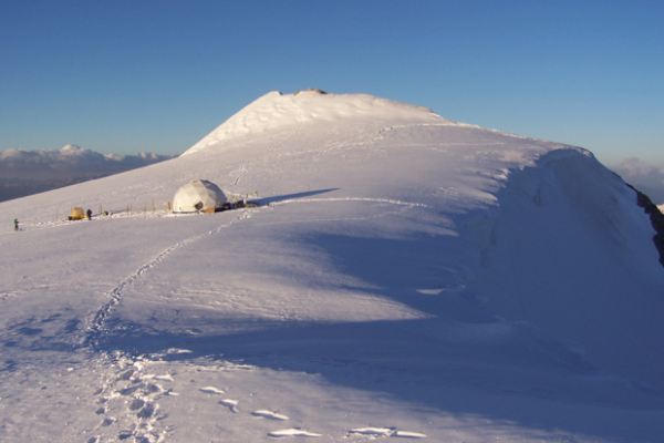 Ice-covered mountain with tent
