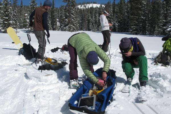 Team of Scientists Assembling Equipment on a Sled