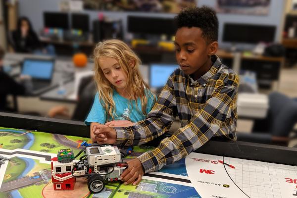 Lego league teammates work on solving their latest challenge.