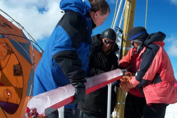 Dr. Lonnie Thompson and two other scientists hold an ice core at the summit of Quelccaya in 2003.