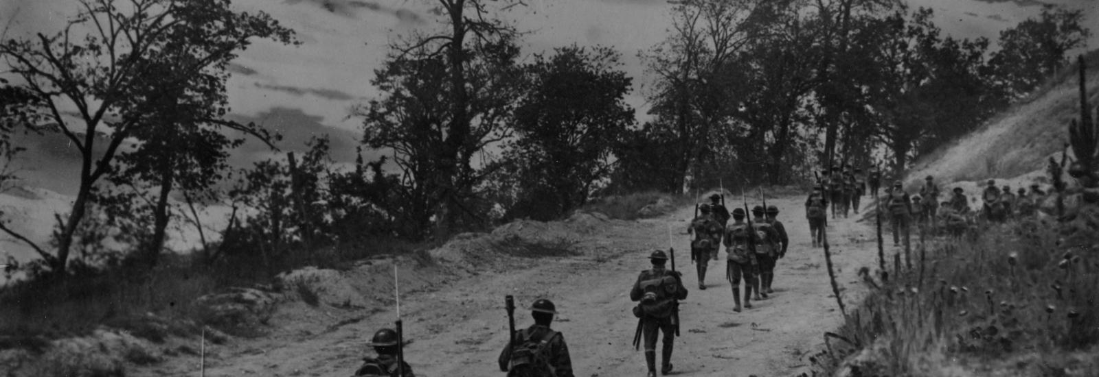American soldiers walking up the road holding  bayonets at Mont St. Quentin